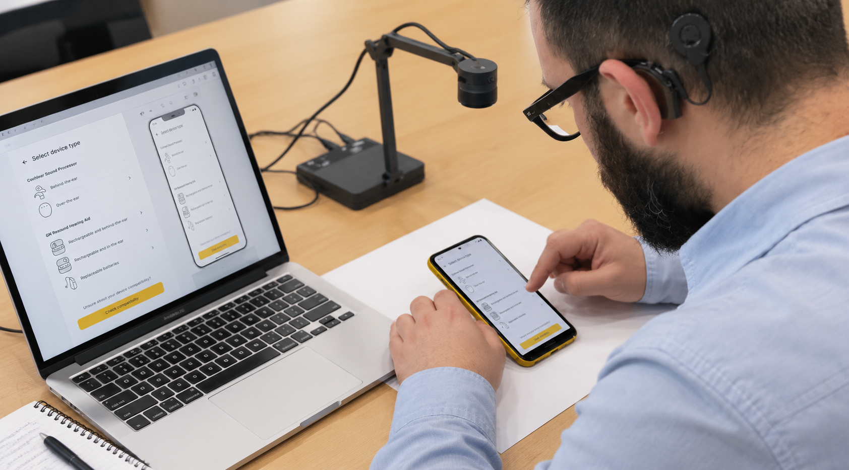 Supporting visual illustrating device-connection usability testing, with a recipient using a phone prototype beside a laptop and observation equipment.